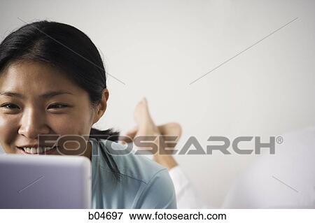 Stock Photo - Female with laptop. Fotosearch