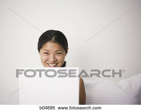 Stock Photography - Female with laptop. Fotosearch