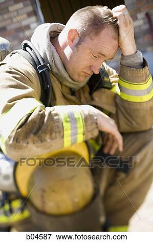 Stock Photo - Fire fighter in uniform scratching his head. Fotosearch