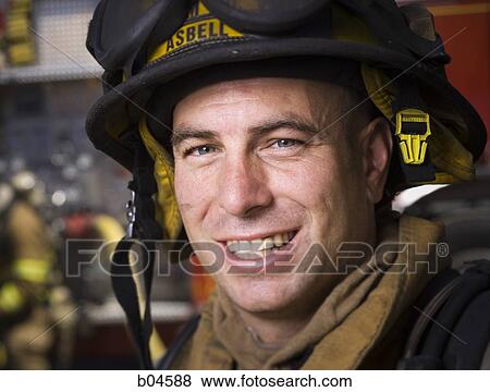 Stock Photo - Fire fighter in uniform smiling. Fotosearch