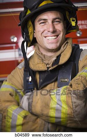 Fire fighter in uniform with Crossed Arms View Large Photo Image Stock Photo - Fire fighter in uniform with Crossed Arms. Fotosearch
