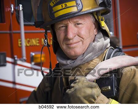 Fire fighter in uniform with hose View Large Photo Image Stock Image - Fire fighter in uniform with hose. Fotosearch