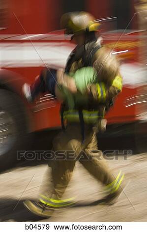 Stock Photo - Fire fighter rescuing child motion blur. Fotosearch