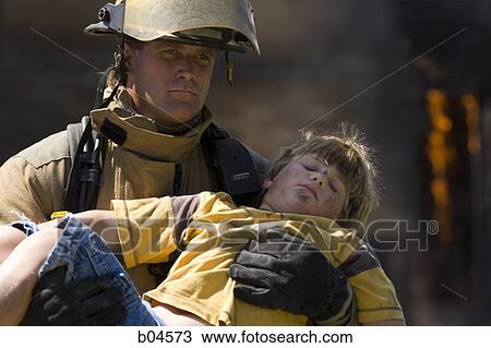 Stock Image - Fire fighter rescuing child. Fotosearch