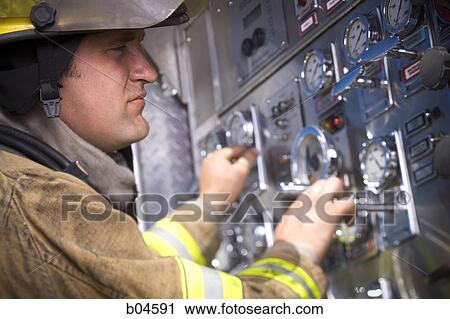 Fire fighter working controls on fire truck View Large Photo Image Stock Image - Fire fighter working controls on fire truck. Fotosearch