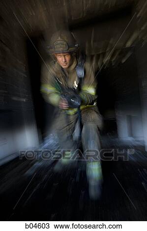 Firefighter facing the camera with hose motion blur View Large Photo Image Stock Image - Firefighter facing the camera with hose motion blur. Fotosearch