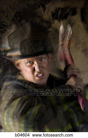 Picture - Firefighter with axe. Fotosearch