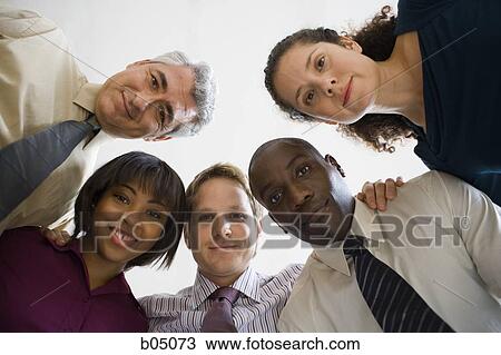 Five businesspeople looking down View Large Photo Image Stock Image - Five businesspeople looking down. Fotosearch