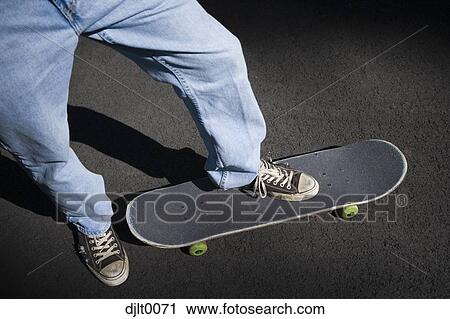 Stock Image - Foot on a skateboard. Fotosearch