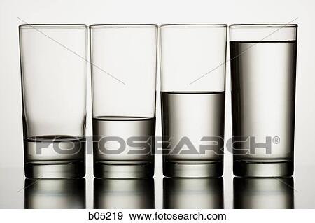 Four glasses of water with varying levels View Large Photo Image Stock Photo - Four glasses of water with varying levels. Fotosearch