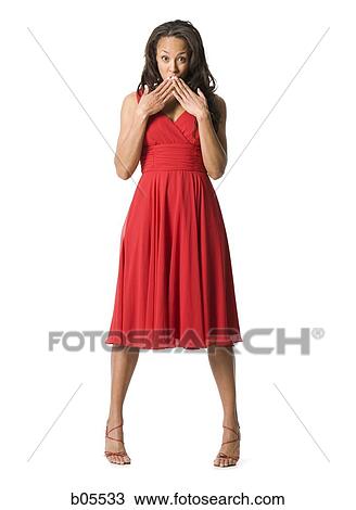 Full length woman in red dress with hands over mouth View Large Photo Image Stock Image - Full length woman in red dress with hands over mouth. Fotosearch