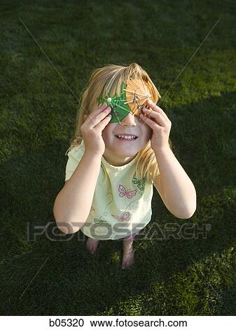 Girl covering eyes with drink umbrellas View Large Photo Image Stock Image - Girl covering eyes with drink umbrellas. Fotosearch