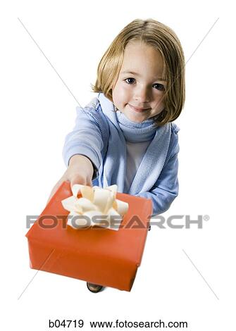 Girl giving Christmas gift View Large Photo Image Stock Photo - Girl giving Christmas gift. Fotosearch