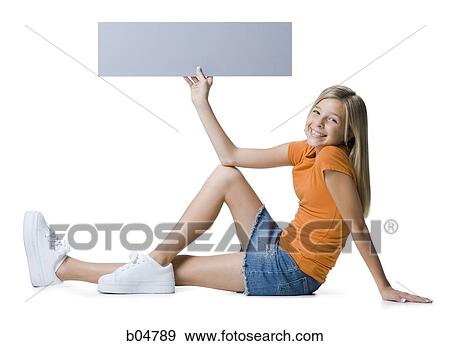 Girl holding blank sign sitting and smiling View Large Photo Image Stock Photo - Girl holding blank sign sitting and smiling. Fotosearch