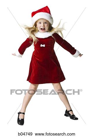 Girl in santa hat jumping View Large Photo Image Stock Photo - Girl in santa hat jumping. Fotosearch