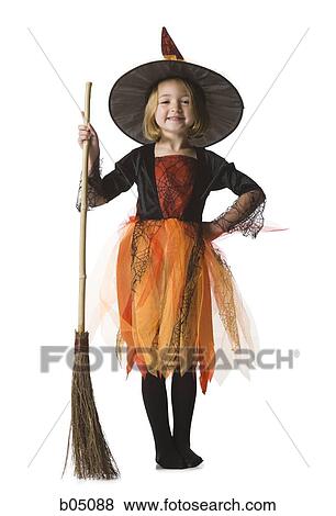 Stock Photo - Girl in witch costume with broom. Fotosearch