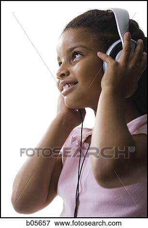 Girl listening to headphones View Large Photo Image Stock Photo - Girl listening to headphones. Fotosearch