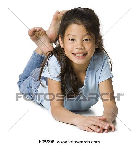 Girl lying on floor with legs crossed View Large Photo Image Stock Photo - Girl lying on floor with legs crossed. Fotosearch