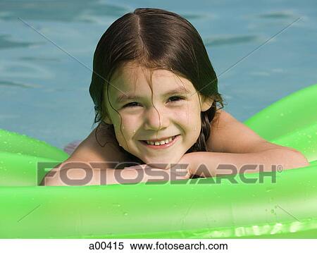 Stock Photography - Girl on floatation device. Fotosearch