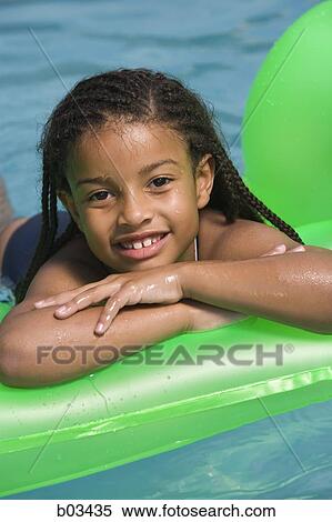 Girl on floatation device View Large Photo Image Stock Photography - Girl on floatation device. Fotosearch