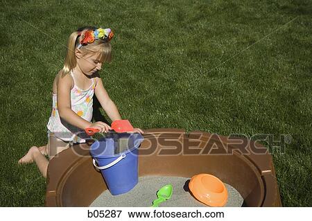 Girl playing in sandbox View Large Photo Image Stock Photo - Girl playing in sandbox. Fotosearch
