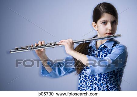 Girl playing the flute View Large Photo Image Stock Image - Girl playing the flute. Fotosearch