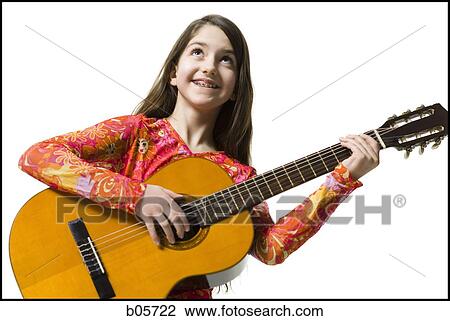 Stock Image - Girl playing the guitar. Fotosearch
