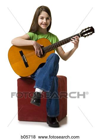 Girl playing the guitar View Large Photo Image Stock Photo - Girl playing the guitar. Fotosearch