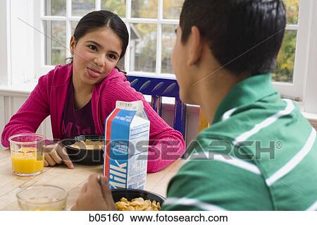 Girl sticking tongue out at breakfast table View Large Photo Image Stock Image - Girl sticking tongue out at breakfast table. Fotosearch
