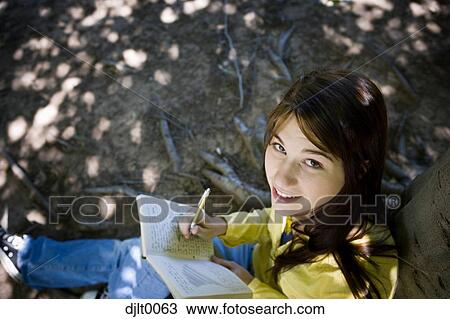 Stock Image - Girl studying outdoors. Fotosearch