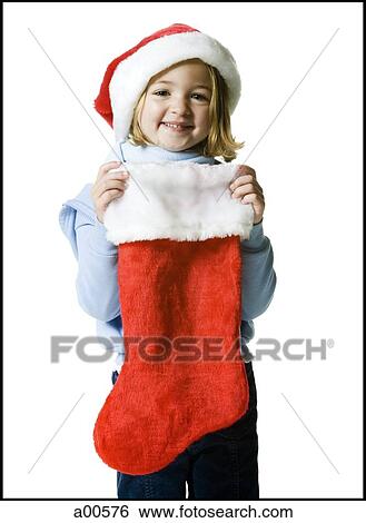 Girl with Christmas stocking and santa hat View Large Photo Image Stock Photograph - Girl with Christmas stocking and santa hat. Fotosearch