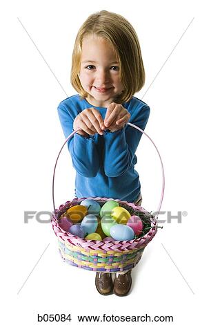 Girl with easter eggs in basket View Large Photo Image Picture - Girl with easter eggs in basket. Fotosearch