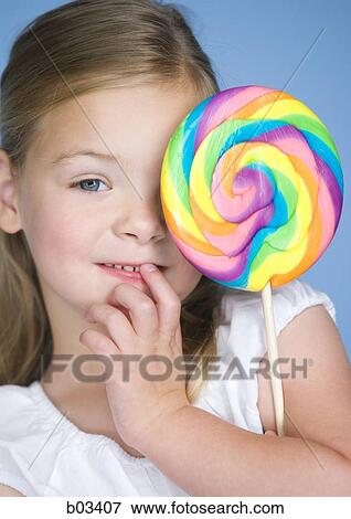 Girl with lollipop View Large Photo Image Stock Photo - Girl with lollipop. Fotosearch