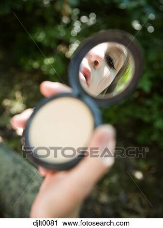 Stock Image - Girl with makeup mirror. Fotosearch