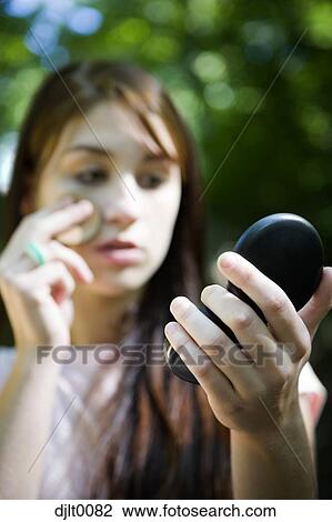 Girl with makeup mirror View Large Photo Image Stock Image - Girl with makeup mirror. Fotosearch