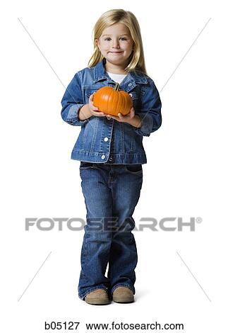 Girl with pumpkin smiling View Large Photo Image Stock Photo - Girl with pumpkin smiling. Fotosearch