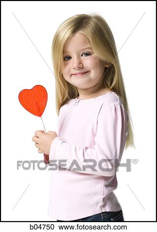 Girl with red heart lollipop View Large Photo Image Stock Image - Girl with red heart lollipop. Fotosearch
