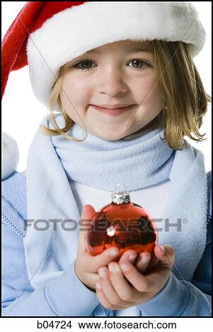 Girl with santa hat and Christmas ornament View Large Photo Image Picture - Girl with santa hat and Christmas ornament. Fotosearch