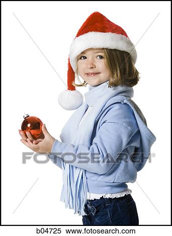 Stock Photography - Girl with santa hat and Christmas ornament. Fotosearch