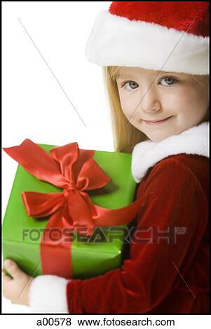 Girl with santa hat and gift View Large Photo Image Stock Photo - Girl with santa hat and gift. Fotosearch