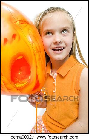 Girl with scary orange balloon View Large Photo Image Stock Photo - Girl with scary orange balloon. Fotosearch