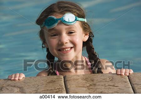 Girl with swimming goggles by pool View Large Photo Image Picture - Girl with swimming goggles by pool. Fotosearch