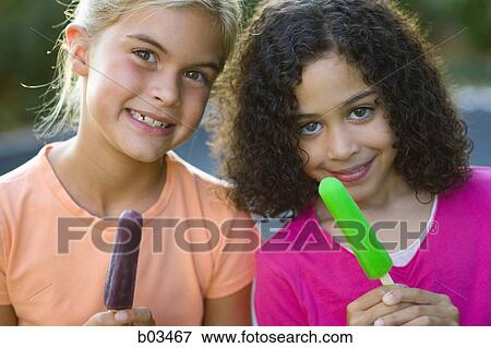 Girls holding popsicles View Large Photo Image Stock Photo - Girls holding popsicles. Fotosearch