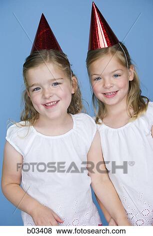 Stock Photo - Girls in party hats. Fotosearch