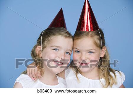 Girls in party hats View Large Photo Image Stock Photo - Girls in party hats. Fotosearch