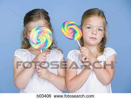 Girls with lollipops View Large Photo Image Stock Photograph - Girls with lollipops. Fotosearch