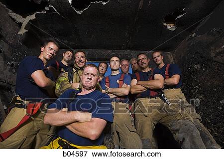 Group portrait of firefighters in burnt room from below View Large Photo Image Stock Photo - Group portrait of firefighters in burnt room from below. Fotosearch