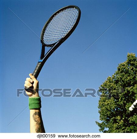 Hand holding a tennis racquet View Large Photo Image Stock Photo - Hand holding a tennis racquet. Fotosearch