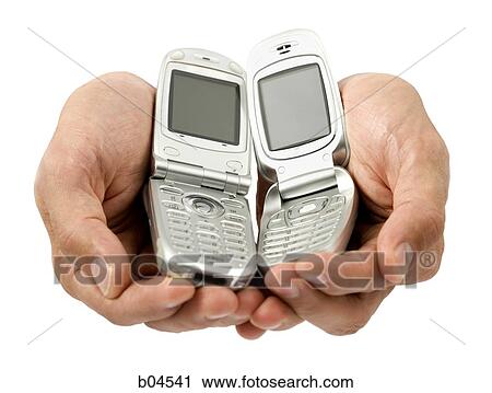 Stock Image - Hand with cell phones. Fotosearch