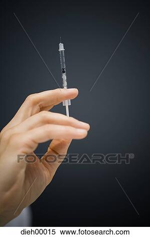 Hand with syringe View Large Photo Image Stock Photography - Hand with syringe. Fotosearch